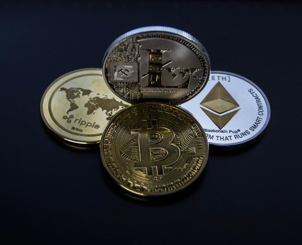 Bitcoin, Ethereum and Ripple cryptocurrency coins on a dark background