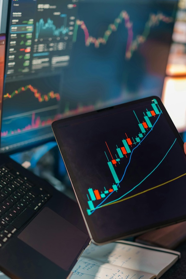 Rising cryptocurrency candlestick chart shown on a tablet screen