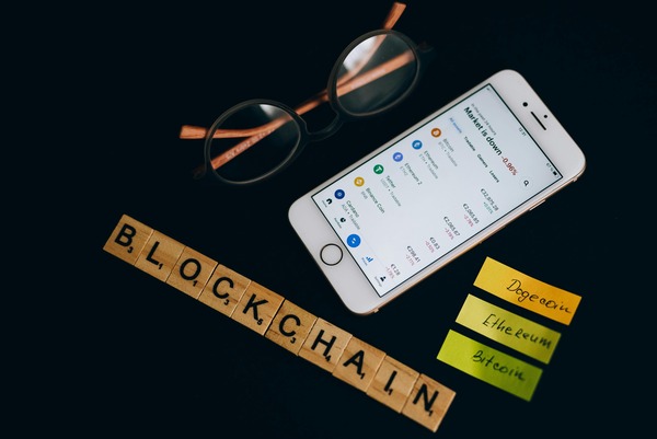 Smartphone showing a cryptocurrency wallet portfolio app with a coin balance list